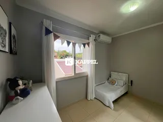 Este é um quarto com cama e janela decorada em uma residência.
