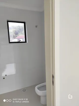 Vista interna de um cômodo com janela em uma residência.