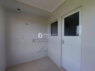 Interior de um corredor com piso de cerâmica e porta branca.
