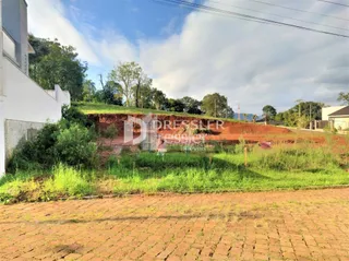 Vista da fachada de uma propriedade com área de terra em construção.
