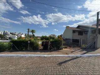 Foto da fachada de uma residência em Lajeado, Brasil, mostrando a cerca e a vegetação ao lado da rua.