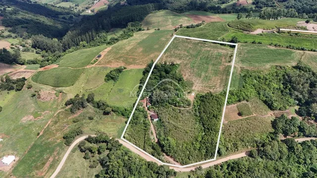 Vista aérea de uma propriedade rural em Lajeado, Brasil, mostrando campos e vegetação.