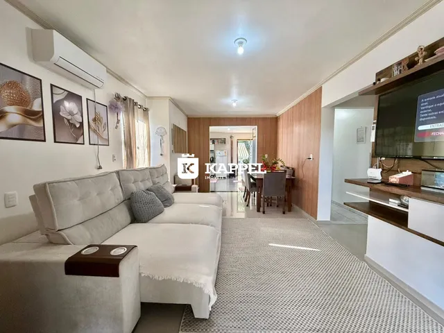 Sala de estar com sofá grande e decoração moderna em um apartamento.