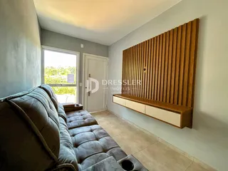 Sala de estar com sofá e painel de madeira na residência.