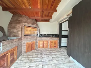 Interior de uma sala com piso de cerâmica e detalhes em madeira.