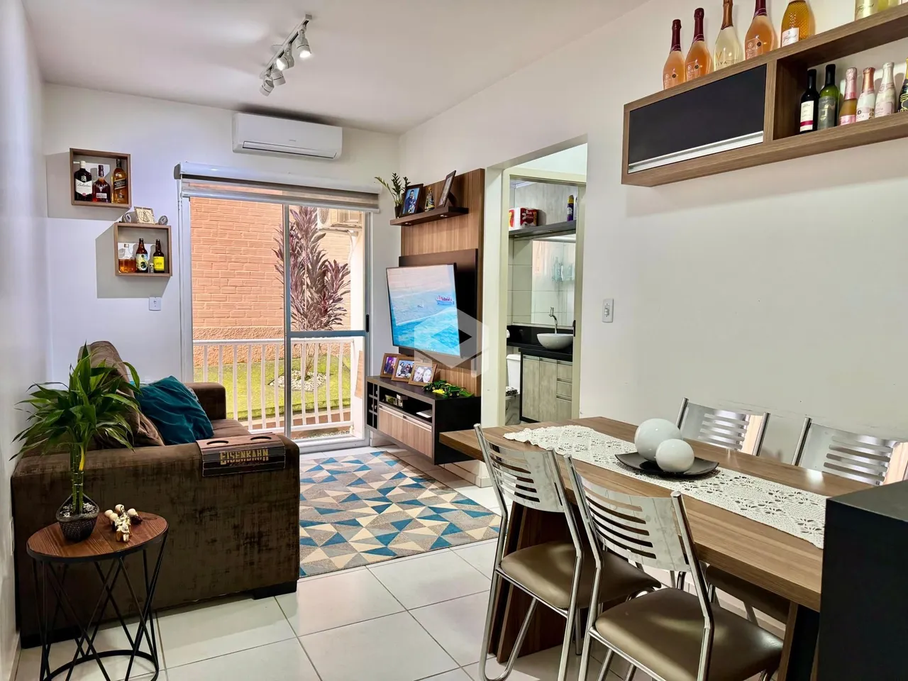 Sala de estar com sofá e mesa de jantar em apartamento.