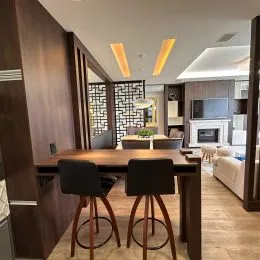 Ambiente interno com mesa de madeira escura em um espaço residencial.