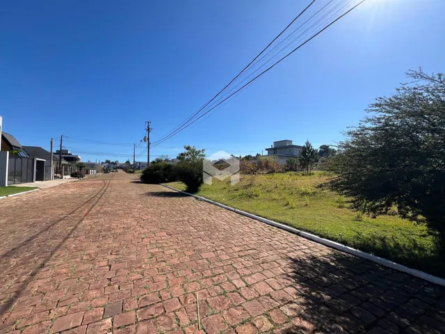 Vista da rua pavimentada em Lajeado, Brasil com área verde ao lado.