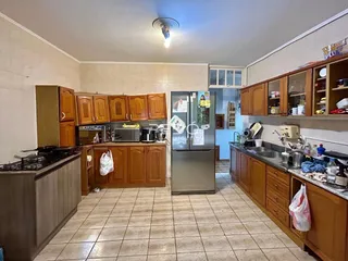 Foto de uma cozinha com armários de madeira e piso de cerâmica.
