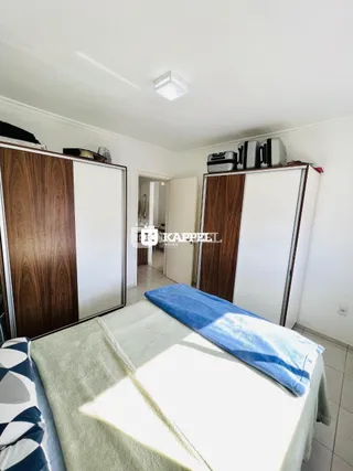 Quarto com cama e armários de madeira.