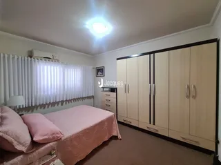 Quarto com cama e janela em ambiente interno.