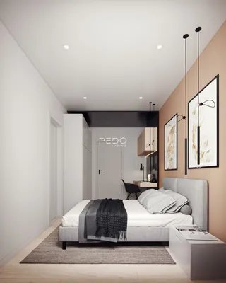 Quarto moderno com cabeceira cinza e decoração minimalista.